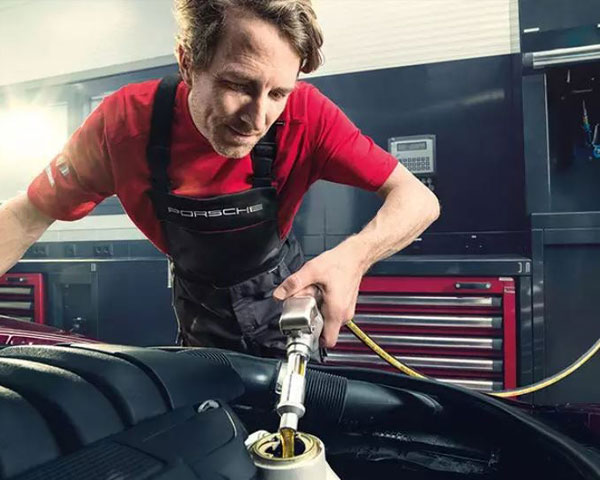 Porsche Technician performing oil service