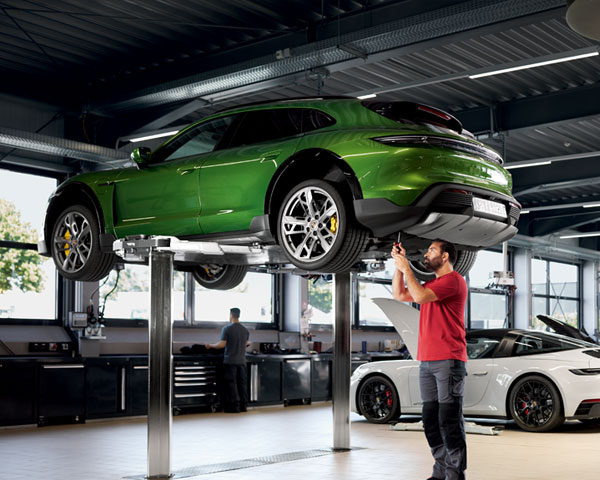 Porsche Technician working on a green Macan